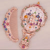 Hand held small mirror with a comb set
